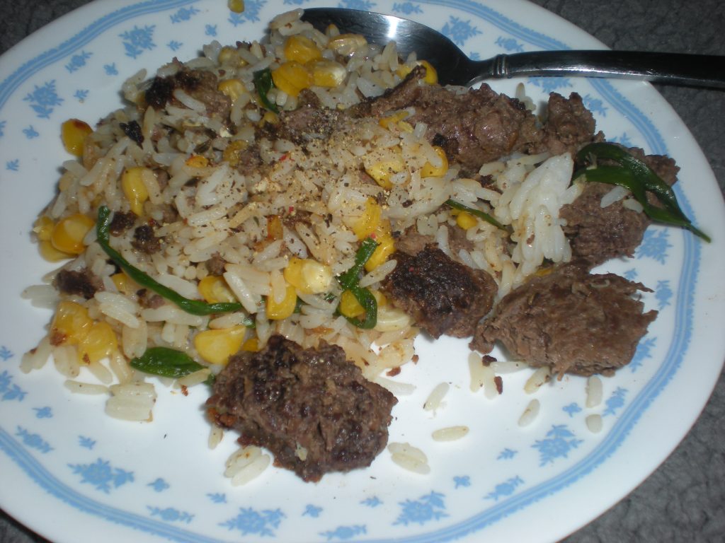 Ground deer meet harvested from deer hunting season in Ohio, cooked with rice, corn, and herbs from the garden.