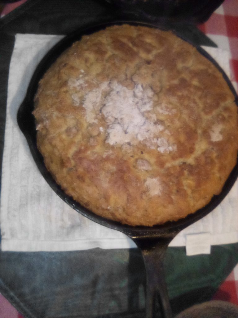 Freshly baked, hot Irish Soda Bread in a cast iron pan.