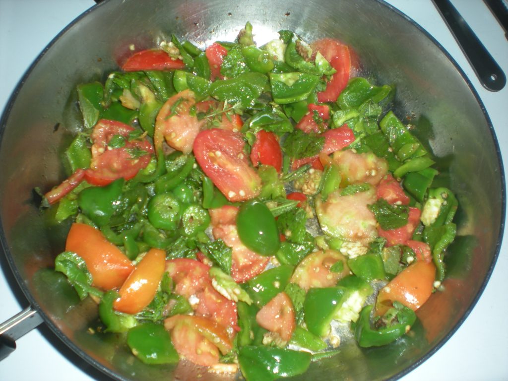 2024 Victory Garden vegetables and herbs frying in pan using lard.