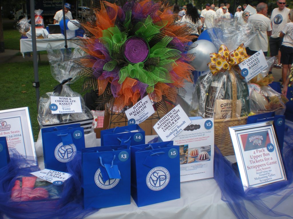 Some Raffle gift baskets at Friends of the Poor Walk/Run Banner: Society of St. Vincent de Paul.