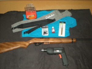 Some of the tools used to install a sling on my Ruger 10/22 Carbine Model 1103 rifle included a drill, bits, thread lock, center punch, and a Grovtec locking swivel set (along with some other items such as a srewdriver, ruler, and tape).